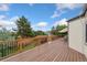 Spacious deck features wood flooring, black metal railings, and offers ample room for outdoor dining and entertaining at 3390 S Ensenada Way, Aurora, CO 80013