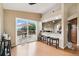 Dining area with hardwood floors, access to deck, and bar seating for entertaining at 3390 S Ensenada Way, Aurora, CO 80013