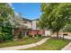 Beautiful home with brick and siding exterior, a two-car garage, and mature trees at 3390 S Ensenada Way, Aurora, CO 80013