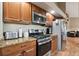 Well-equipped kitchen with stainless steel appliances, granite counters and classic wood cabinets at 3390 S Ensenada Way, Aurora, CO 80013