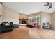 Spacious living room featuring hardwood floors, a brick fireplace, and lots of natural light at 3390 S Ensenada Way, Aurora, CO 80013