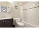 Bright bathroom features a shower over tub and storage in the vanity's dark wood cabinets at 3471 W Exposition Ave, Denver, CO 80219