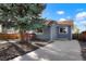 Exterior view of the house with driveway and attractive tree at 3471 W Exposition Ave, Denver, CO 80219