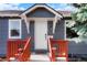 Inviting front entrance with a red stairway and white door at 3471 W Exposition Ave, Denver, CO 80219
