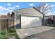 Grey detached garage with a white garage door and concrete driveway at 3471 W Exposition Ave, Denver, CO 80219