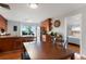 Open kitchen and dining area featuring wood cabinets, stainless steel appliances, and hardwood floors at 3471 W Exposition Ave, Denver, CO 80219