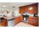 Functional kitchen with stainless steel appliances and wood cabinets at 3471 W Exposition Ave, Denver, CO 80219
