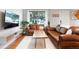 Comfortable living room with hardwood floors, leather sofas, and bright window at 3471 W Exposition Ave, Denver, CO 80219