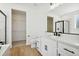 Modern bathroom with white cabinets, black hardware, and a glass-enclosed shower at 42974 Colonial Trl, Elizabeth, CO 80107