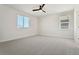 Minimalist bedroom with neutral carpet, two windows, and ample natural light at 42974 Colonial Trl, Elizabeth, CO 80107