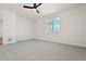 Clean bedroom with a ceiling fan, a view from the window, and neutral colored carpet at 42974 Colonial Trl, Elizabeth, CO 80107