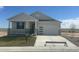 Charming single-Gathering home with a covered porch and a two-car garage, set against a clear blue sky at 42974 Colonial Trl, Elizabeth, CO 80107