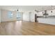 Open-concept living space with hardwood floors and a view of the modern kitchen at 42974 Colonial Trl, Elizabeth, CO 80107