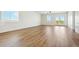 Bright and airy living room with hardwood floors and a sliding glass door to a patio at 42974 Colonial Trl, Elizabeth, CO 80107