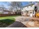 Large backyard with stone patio, grass, and access to garage at 4244 Grove St, Denver, CO 80211