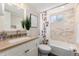 Clean bathroom with tiled shower/tub and modern vanity at 4244 Grove St, Denver, CO 80211