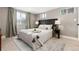 Cozy bedroom with patterned headboard, neutral tones, and ample natural light at 4244 Grove St, Denver, CO 80211