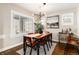This dining room features a decorative chandelier, a large window and a black and white piece of art at 4244 Grove St, Denver, CO 80211