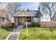 Charming brick bungalow with inviting front porch and well-manicured lawn at 4244 Grove St, Denver, CO 80211