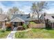 Charming brick bungalow with inviting front porch, lovely yard, and mature trees at 4244 Grove St, Denver, CO 80211