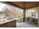 Relaxing front porch with swing, blue cushions, and view of the neighborhood at 4244 Grove St, Denver, CO 80211