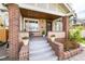 Inviting front porch with brick accents, swing, and decorative flower pots at 4244 Grove St, Denver, CO 80211