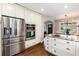 Modern kitchen with stainless steel appliances, granite counters, and hardwood floors at 4244 Grove St, Denver, CO 80211