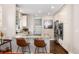 Well-lit kitchen with stainless steel appliances, granite counters and barstool seating at 4244 Grove St, Denver, CO 80211
