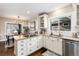 Bright kitchen featuring granite counters, stainless steel appliances, and hardwood floors at 4244 Grove St, Denver, CO 80211