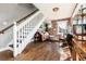 View of living room with white staircase and brick wall at 4244 Grove St, Denver, CO 80211
