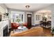 Open living room with hardwood floors that flows into the adjacent dining area at 4244 Grove St, Denver, CO 80211