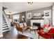 Spacious living room with a fireplace, hardwood floors, and staircase to the second level at 4244 Grove St, Denver, CO 80211
