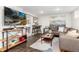 Stylish living room featuring a large TV, bar seating, and comfortable sectional at 4244 Grove St, Denver, CO 80211