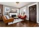 Cozy living room with a fireplace, hardwood floors, and ample natural light at 4244 Grove St, Denver, CO 80211