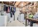 This basement includes a washer and dryer, storage shelves, and space for hanging clothes at 9120 W Bellwood Pl, Littleton, CO 80123