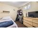 Basement bedroom with carpet flooring, dresser, shelving, and a cozy bed at 9120 W Bellwood Pl, Littleton, CO 80123