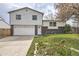 Charming two-story home with a brick-accented facade, well-manicured lawn, driveway, and garage at 9120 W Bellwood Pl, Littleton, CO 80123