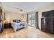 Comfortable main bedroom with hardwood floors, ceiling fan, backyard access, and stylish furniture at 9120 W Bellwood Pl, Littleton, CO 80123