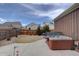 Private backyard featuring a well-maintained lawn and a luxurious hot tub at 4483 Fell Mist Way, Castle Rock, CO 80109