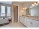 Bright bathroom featuring a double vanity, neutral walls and floors, and a soaking tub in the corner at 4483 Fell Mist Way, Castle Rock, CO 80109