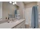 Clean bathroom with a quartz countertop, sink, mirror, and shower with bathtub at 4483 Fell Mist Way, Castle Rock, CO 80109