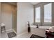 Bright bathroom features a soaking tub next to window and glass-enclosed shower at 4483 Fell Mist Way, Castle Rock, CO 80109
