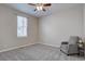 Bedroom features a ceiling fan, window, and seating area, creating a cozy and inviting space at 4483 Fell Mist Way, Castle Rock, CO 80109