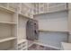 Spacious walk-in closet with custom shelving and ample storage space for clothes and accessories at 4483 Fell Mist Way, Castle Rock, CO 80109