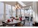 Sunlit dining area featuring a modern chandelier, and sliding glass doors leading to a covered patio at 4483 Fell Mist Way, Castle Rock, CO 80109