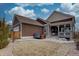 Rear exterior view of a home featuring a lawn, a hot tub, and neutral siding at 4483 Fell Mist Way, Castle Rock, CO 80109