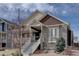 Charming two-story home featuring a stone facade and inviting front porch with painted white stairs at 4483 Fell Mist Way, Castle Rock, CO 80109