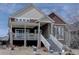 Charming two-story home featuring a stone facade and inviting front porch with painted white stairs at 4483 Fell Mist Way, Castle Rock, CO 80109
