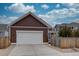 Charming home with a white garage door, vertical siding and a concrete driveway at 4483 Fell Mist Way, Castle Rock, CO 80109