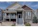 Charming two-story home with mixed stone and siding, covered porch, and well-maintained landscaping at 4483 Fell Mist Way, Castle Rock, CO 80109